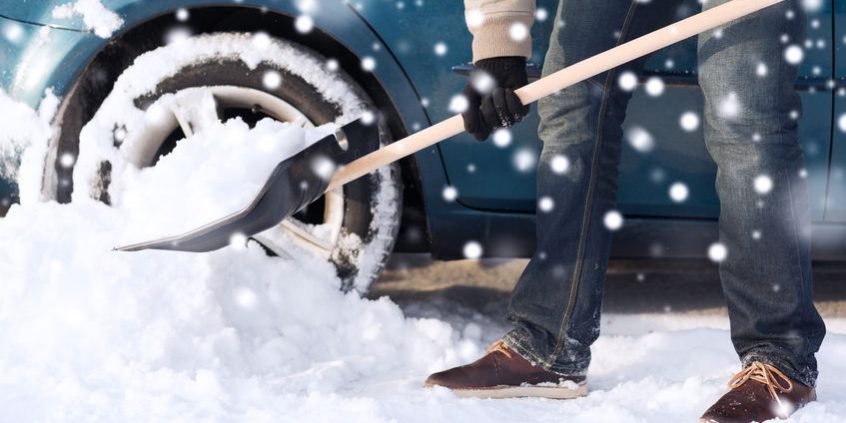 32777001_s transportation, winter, people and vehicle concept - closeup of man digging snow with shovel near car