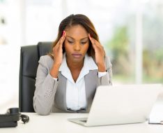 30664548 - stressed african businesswoman sitting in office