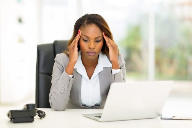 30664548 – stressed african businesswoman sitting in office