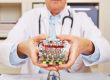 doctor holding many different colorful pills in in hands