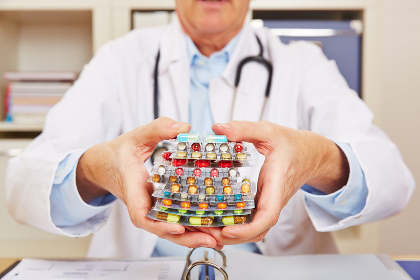doctor holding many different colorful pills in in hands