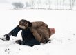 senior man with injured leg falling on snow.