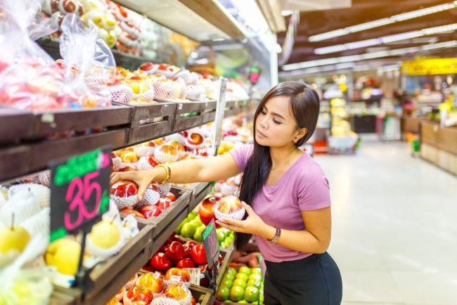 Beautiful asian women shopping vegetables and fruits in supermarket